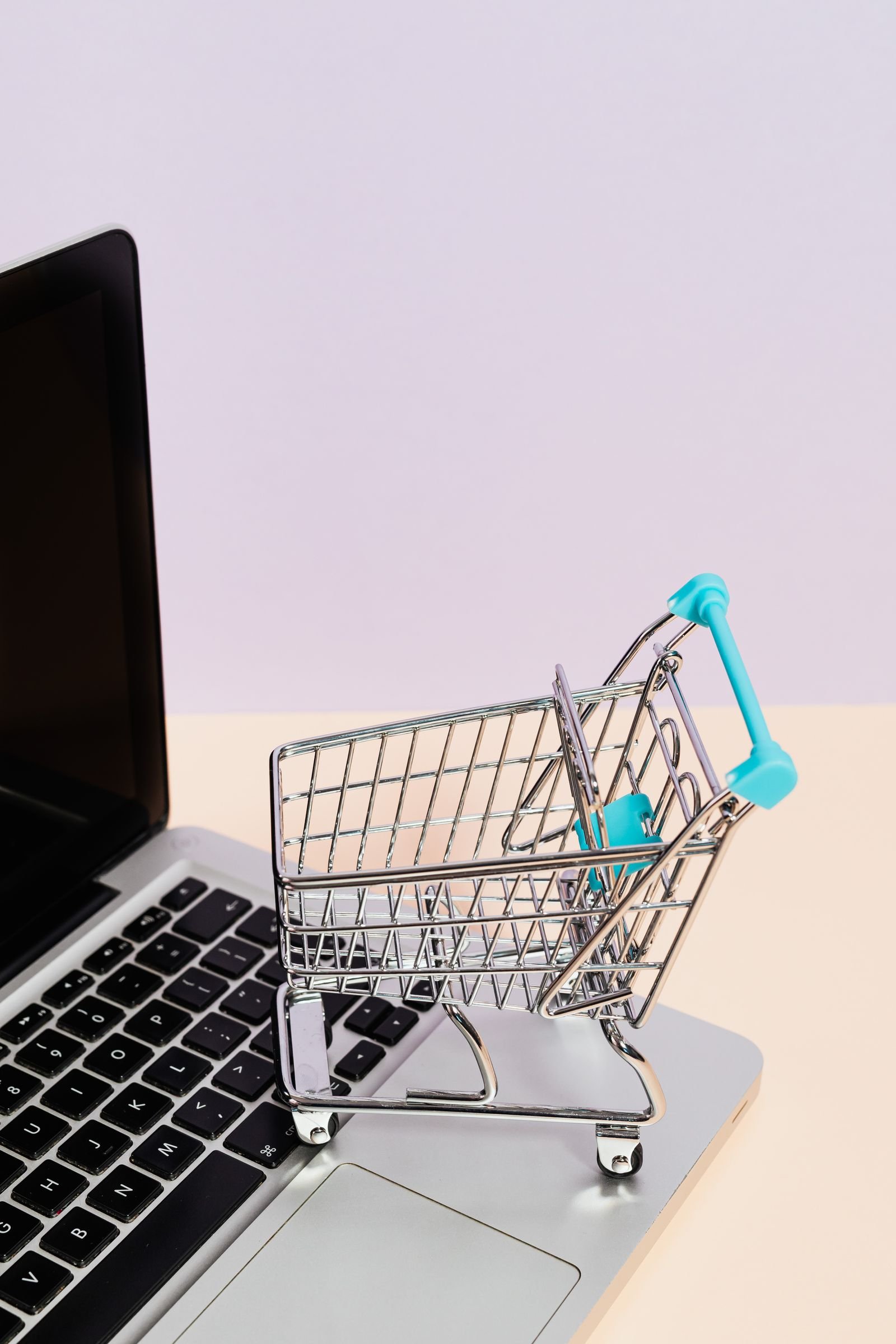 Carrinho de compras e laptop representando venda online, imagem ilustrativa